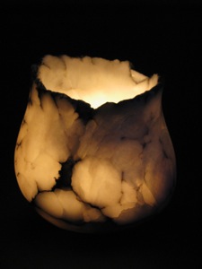 Medium sized alabaster stone bowl by artist Paul Hawkins illuminates a large room at night